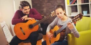 Guitar teachers with young student